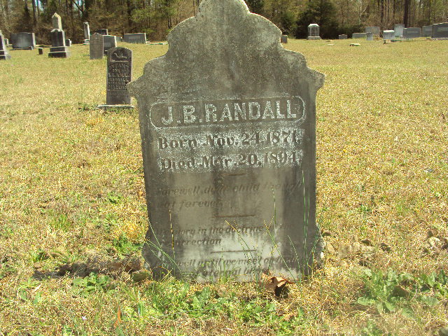 Inscribed: \\ 
J.B. Randall \\
 Born Nov. 24, 1871 \\ 
Died Mar. 20, 1894 \\
Farewell dear child, though not forever. \\
Memory in the doctrine of the resurrection. \\
Farewell until we meet on the... eternal...
