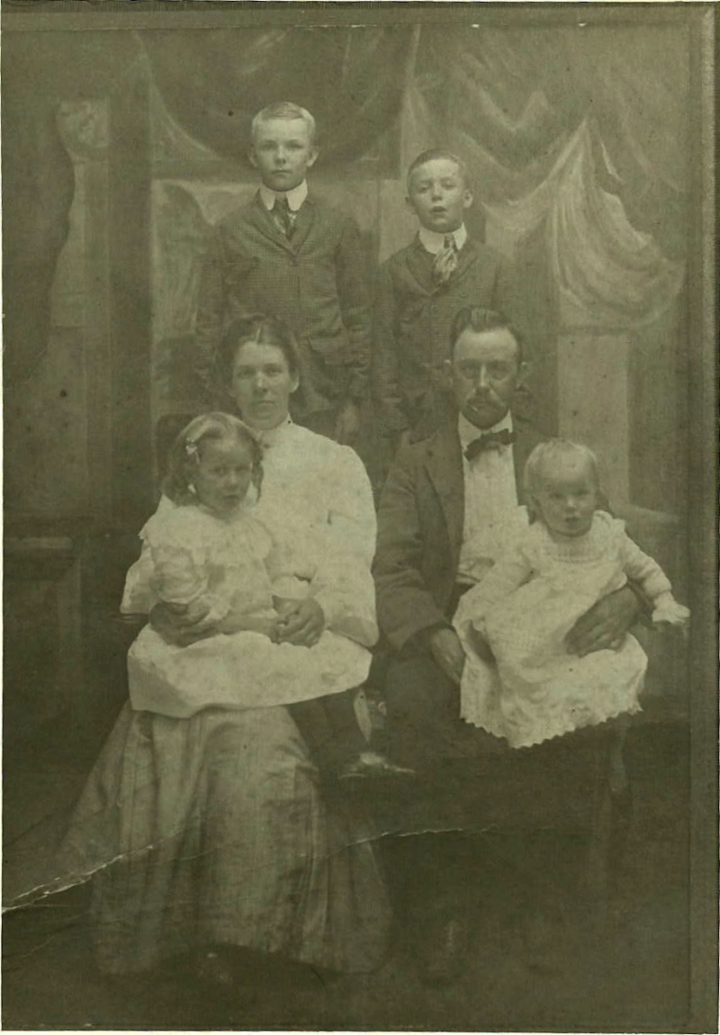 Front Row: Verdie_Fronie Randall seated in Martha Jane "Janie" Randall's lap. John Robert Randall holding Grady Randall in lap. Rear Row (standing): Clarence Randall (Left) & Clyde Randall (Right).