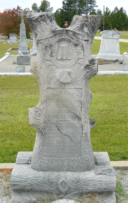 Full tombstone for William R. Randall. At the top of the tombstone is inscribed: "Erected by the Woodsmen of the World".
