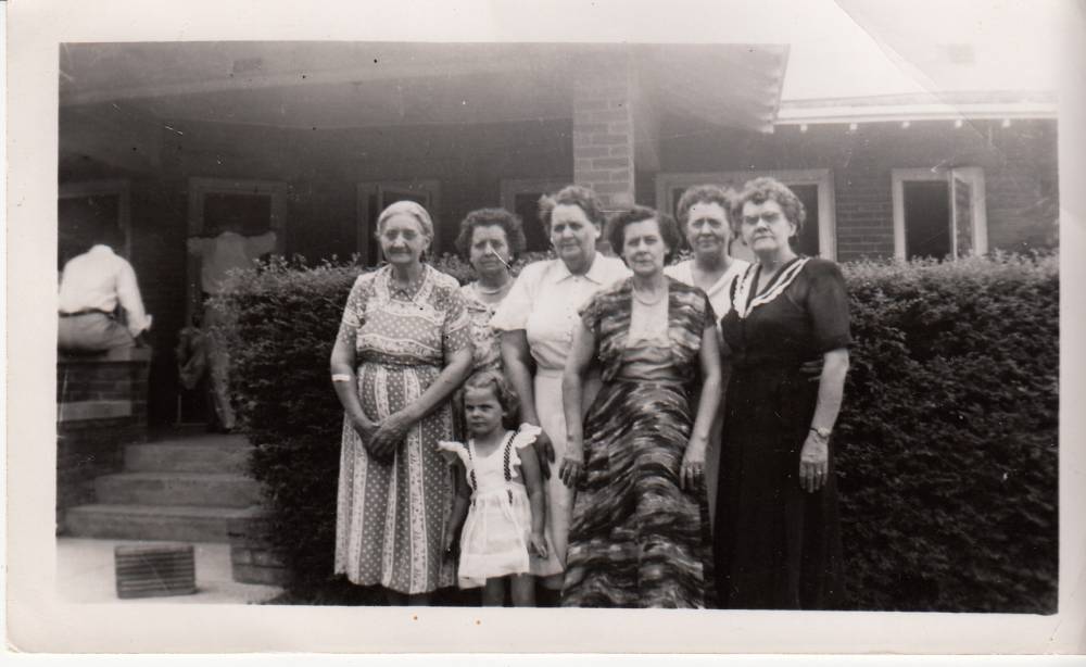 The Madden sisters at 1949 family reunion. Photo taken at Bessie and Joe Rogers' house in Decatur, Texas. Adults from Left to Right: May Madden Cherry, Byrtie Madden Roark Taylor, Blanche Madden Braesicke, Bessie Madden Rogers, Lois Madden Batdorf Keith & Bela Madden Carroll. The little girl is Merrill Rogers.((http://www.wikitree.com/photo/jpg/Madden-284)) Photo courtesy of Ted C. Bergstrom.((http://www.wikitree.com/wiki/Bergstrom-38))