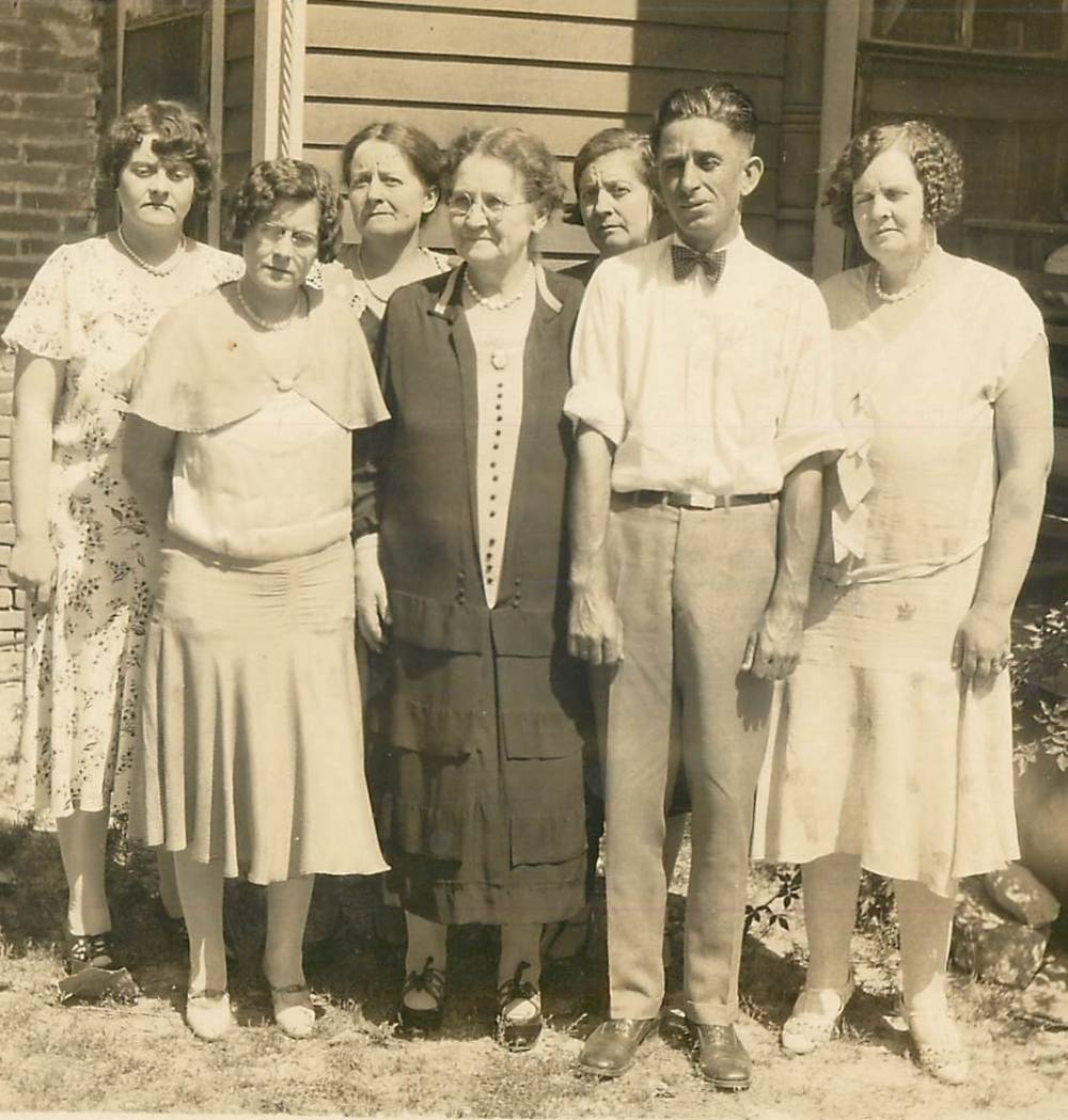 Susan “Susie” Jane Randall-Madden (dressed in black), age 76, with some of her children. Circa 1938. The male (to her left) appears to be her son, Henry Otto Madden, Sr.